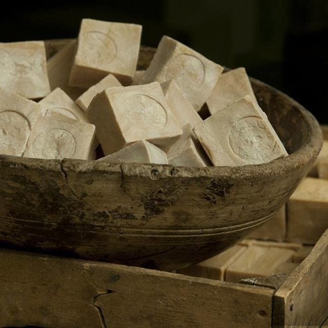 Large old clay bowl containing many pieces of handmade soap from the Nablus Soap Factory